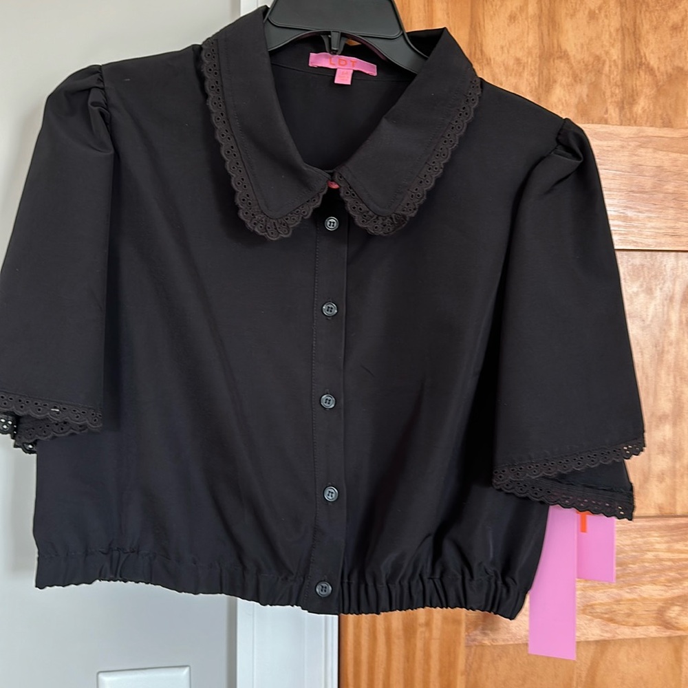 Ladies crop button up with collar and elastic waist band at bottom.
